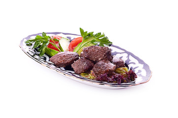 Meat on a grill with vegetables