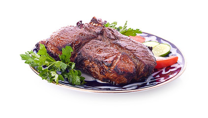 Meat on a grill with vegetables