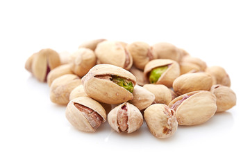 Heap of pistachios nuts isolated on the white