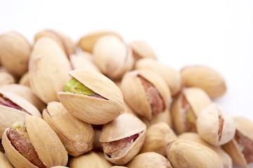 Heap of pistachios nuts isolated on the white