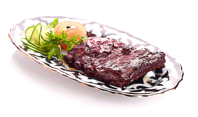 Meat on a grill with vegetables