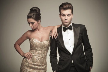 Elegant woman looking down while leaning on her lover