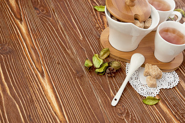 tea with sugar cubes on wooden
