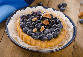Tart with blueberries  on a wooden table