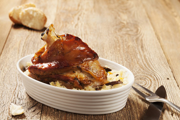 Roast pork knuckle served with boiled cabbage, bread, horseradis