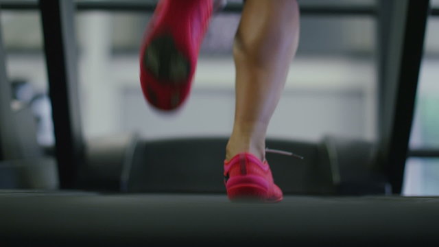 Young woman runs on a treadmill