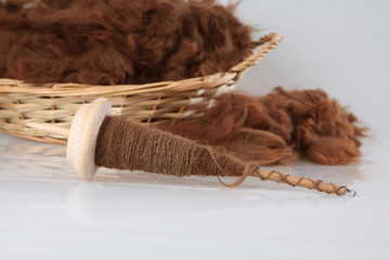 Braune Alpakawolle mit der Handspindel gesponnen