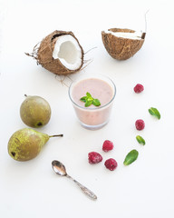 Glass of raspberry, coconut, banana and pear smoothie