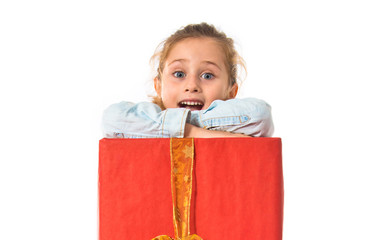 Blonde little girl holding a big red gift