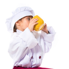 Girl dressed like chef  holding a cup of coffee