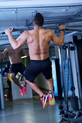 Obraz na płótnie Canvas handsome man exercising at the gym