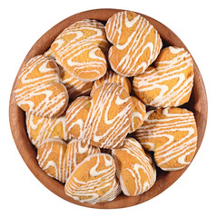 Cookies in heart shape in a wooden bowl on a white