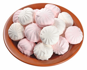 White and pink marshmallow on a ceramic plate on a white