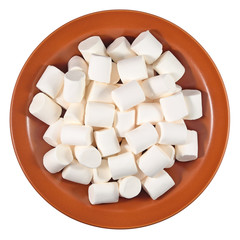 White marshmallow on a ceramic plate on a white