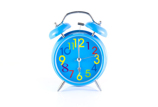 Alarm Clock isolated on white, in blue, showing six o'clock.