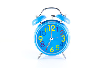Alarm Clock isolated on white, in blue, showing seven o'clock.