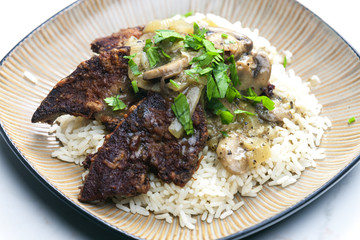 fried livres with mushroom sauce and rice