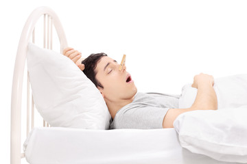 Man sleeping with a clothespin on his nose