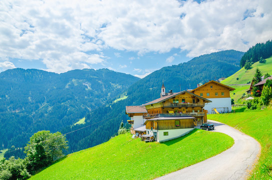 Typical alpine building on a background of green meadows