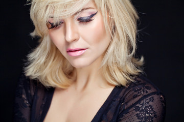 Portrait sexy blonde in studio, black background