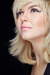 Portrait sexy blonde in studio, black background