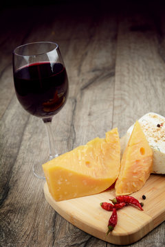 Cheese on the table with glass of wine