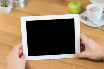 Wooden Table with Small Flower Vase at the Corner.