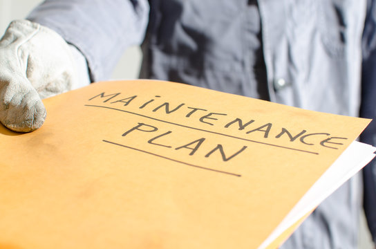 Worker holding a folder of maintenance plan