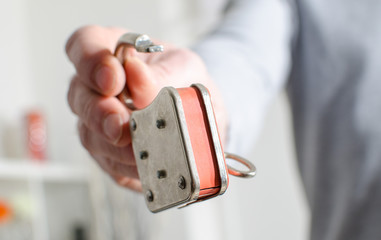 Hand holding an opened padlock