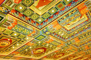 Gilded red patterns on the ceiling in interior of the Po Lin Mon