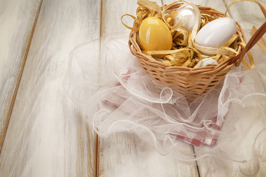 Basket with eggs on picnic table