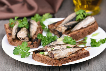 Sandwiches with sprats and green onion