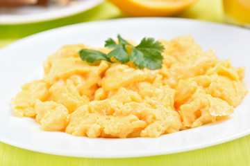 Scrambled eggs on white plate