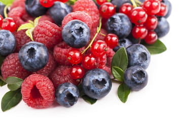 Many blueberries, raspberries. Isolated white