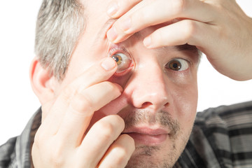 putting on a contact lens