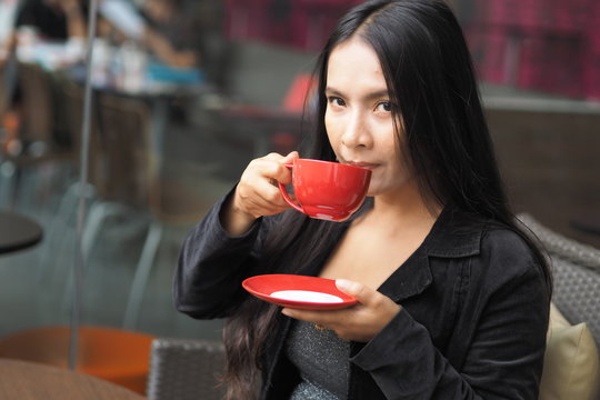 Asian woman with cup of coffee