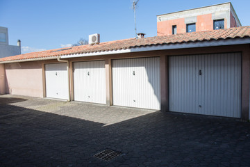 Fototapeta na wymiar Garage building made of concrete with roller shutter doors