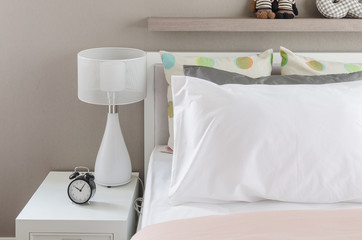kid's bedroom with white pillows and lamp on modern bed