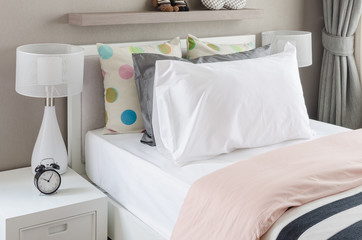 kid's bedroom with white pillows and lamp on modern bed