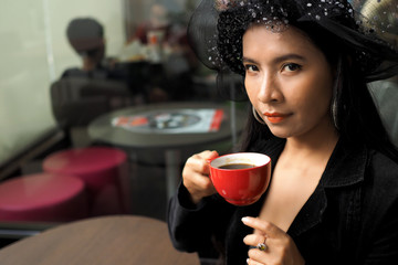Asian woman with cup of coffee