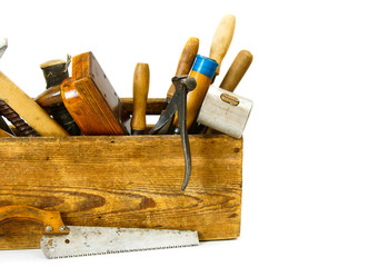 Working tools in an old box on white background.