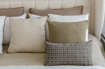 brown pillows on bed in bedroom