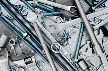 Many tools on the scratched metal background.