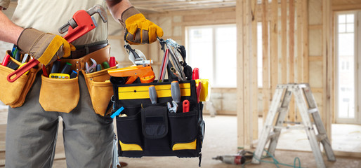 Builder handyman with construction tools.