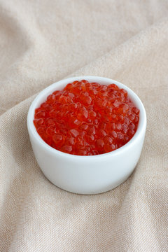Red caviar in a white bowl