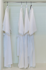 row of  bathrobe hangs in wardrobe