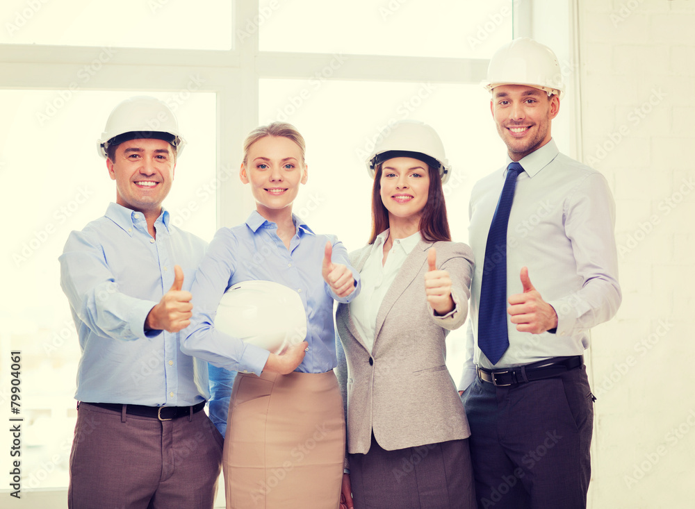 Wall mural happy business team in office showing thumbs up