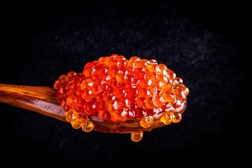 fresh red caviar in a wooden spoon
