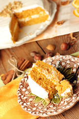 Carrot cake on a wooden table with oranges and spices