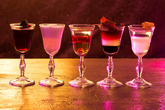Five alcohol chots on table. Club. Night life